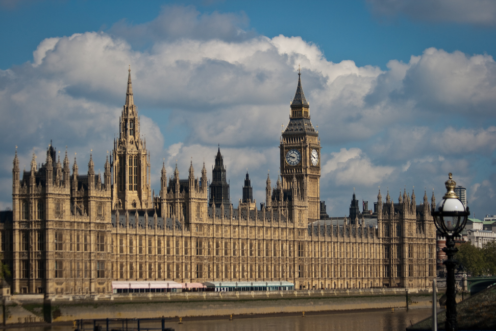 The UK Houses of Parliament: a large gothic building with a prominent clocktower, viewed from across a river.